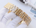 Gold-tone metal watch bracelet with linked segments and clasp