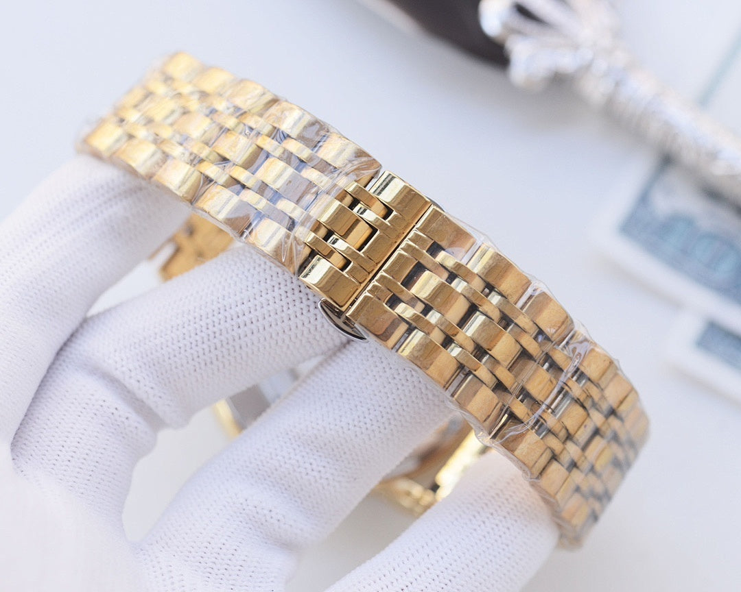 Gold-tone metal watch bracelet with linked segments and clasp