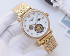 Gold-tone metal watch with white dial, diamond bezel, and skeleton movement
