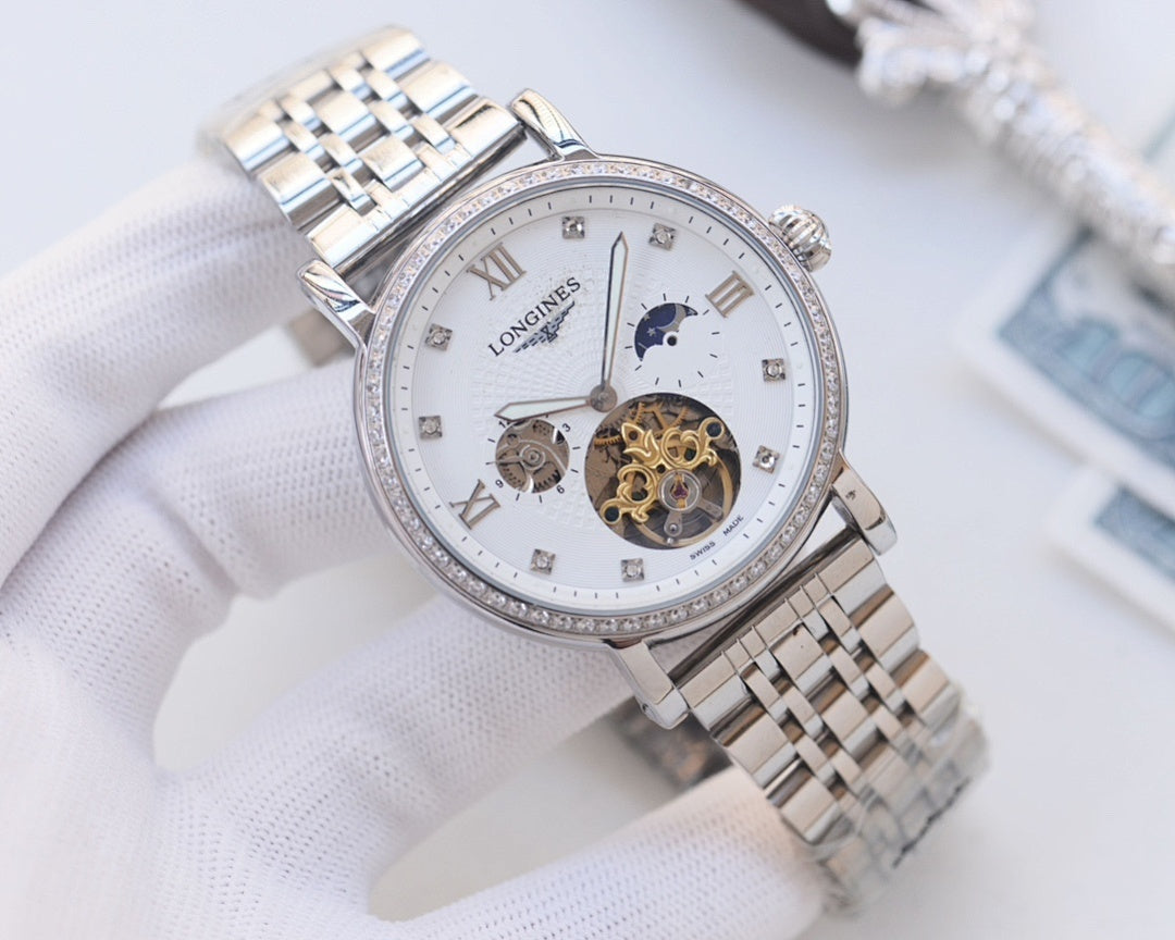 Silver-tone metal watch with white dial, diamond bezel, and visible skeleton movement