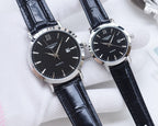 Longines quartz wristwatch with black leather strap and dark dial, Roman numerals