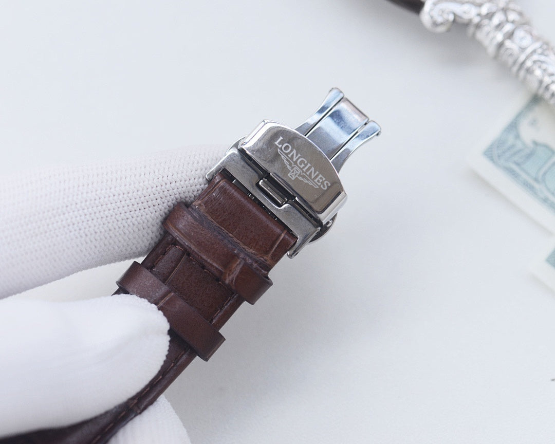 Longines watch clasp and caseback with brown leather strap, metal buckle detail