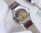 Longines watch caseback with exposed movement on brown leather strap, engraved metal