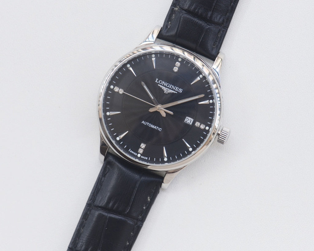 Longines watch with black leather strap, silver-tone case, dark blue dial and date window