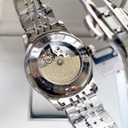 Stainless steel Longines watch case back with exposed movement and engraved branding