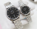 Quartz wristwatches with black dial and silver metal link bracelet, two-pack.