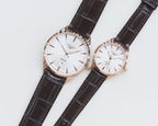 Quartz wristwatches with white dial and brown leather strap, two-pack.