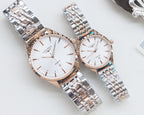 Quartz wristwatches with white dial and silver metal bracelet, rose-gold tone cases, two-pack.