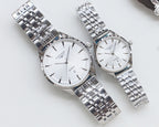 Quartz wristwatches with white dial and silver metal link bracelet, two-pack.