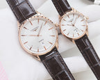 Quartz wristwatches with white dial and brown leather strap, rose-gold tone cases, two-pack.