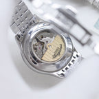 Longines watch caseback showing mechanical movement under clear glass
