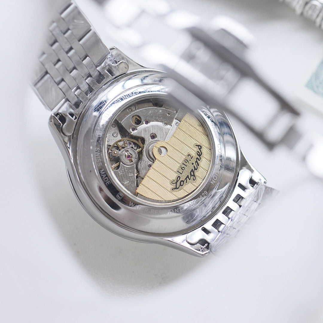 Longines watch caseback showing mechanical movement under clear glass