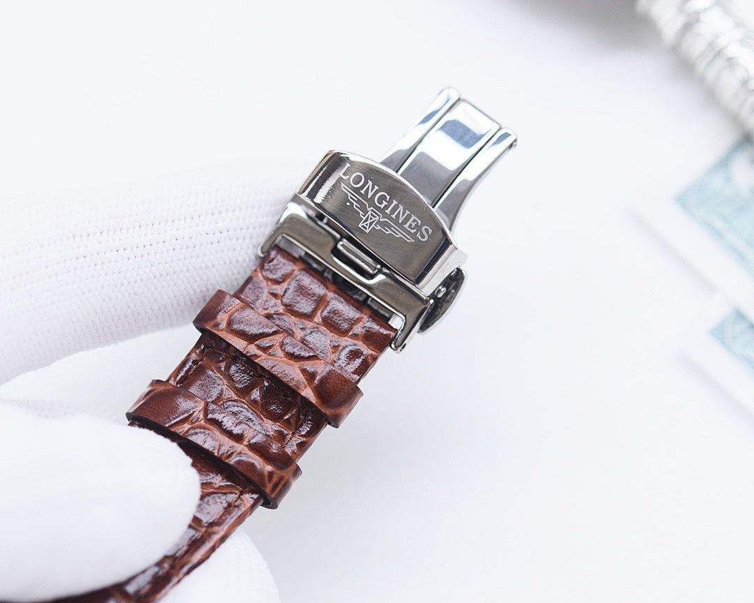 Longines watch with silver case, brown crocodile-style leather strap, logo on buckle