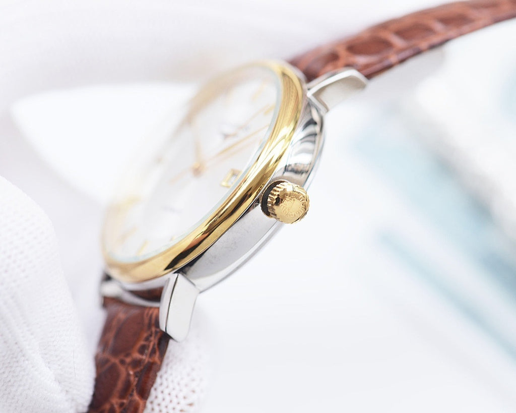 Longines watch side view with gold-tone bezel, silver case, brown leather strap, crown detail