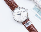 Longines watch with silver case, white dial, brown leather strap, date window at 4