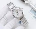 Longines watch, silver metal bracelet, white dial with moon-phase display.