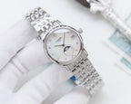 Longines watch, silver metal bracelet, white dial and moon-phase window.