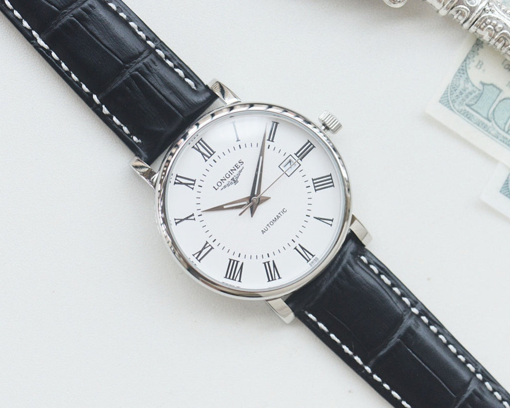 Longines automatic wristwatch, silver-tone case, white dial, black leather strap, angled