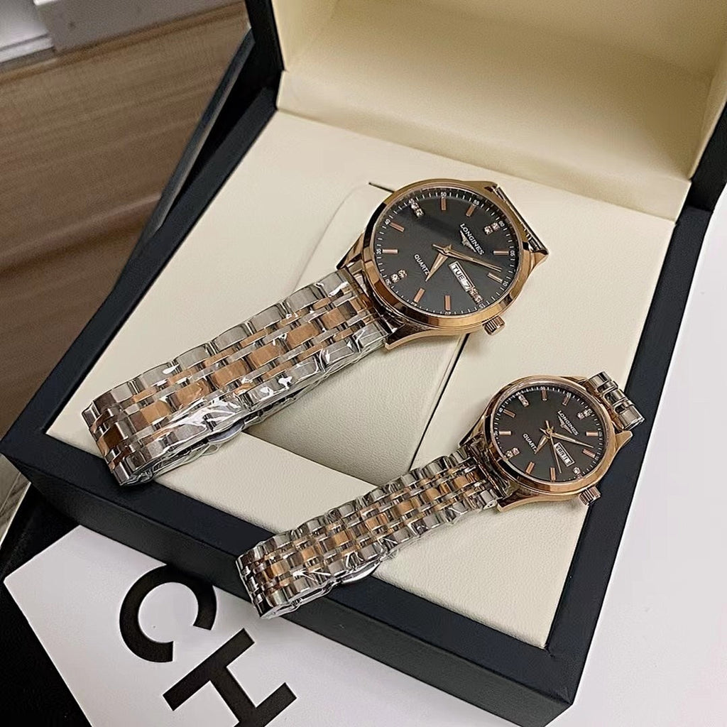 Longines watch pair on display, black dial and silver metal link bracelet