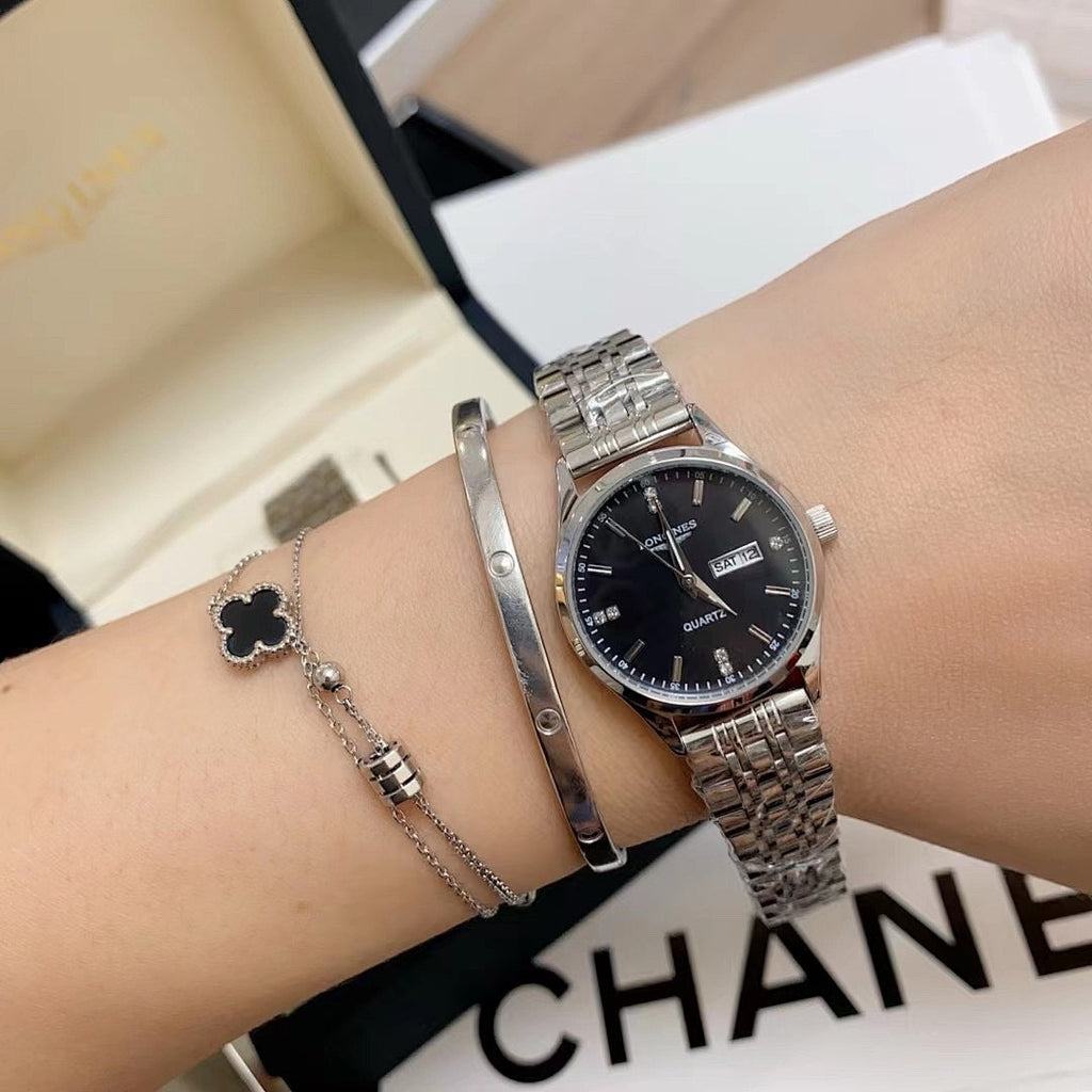 Longines watch on wrist, black dial with silver metal link bracelet
