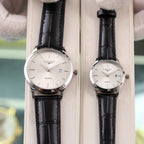 Two Longines quartz watches with black leather straps and white dials, date window