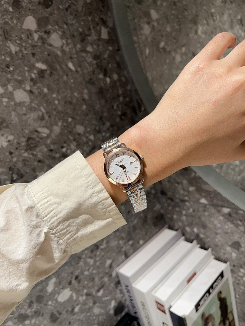 Longines watch with white dial and silver metal bracelet on a wrist