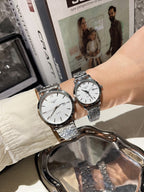 Longines watch with white dial and silver metal bracelet, paired with another watch on wrist