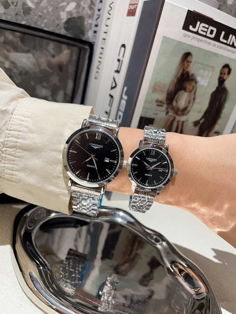 Longines watch set with dark dials and silver metal bracelets held together in a hand