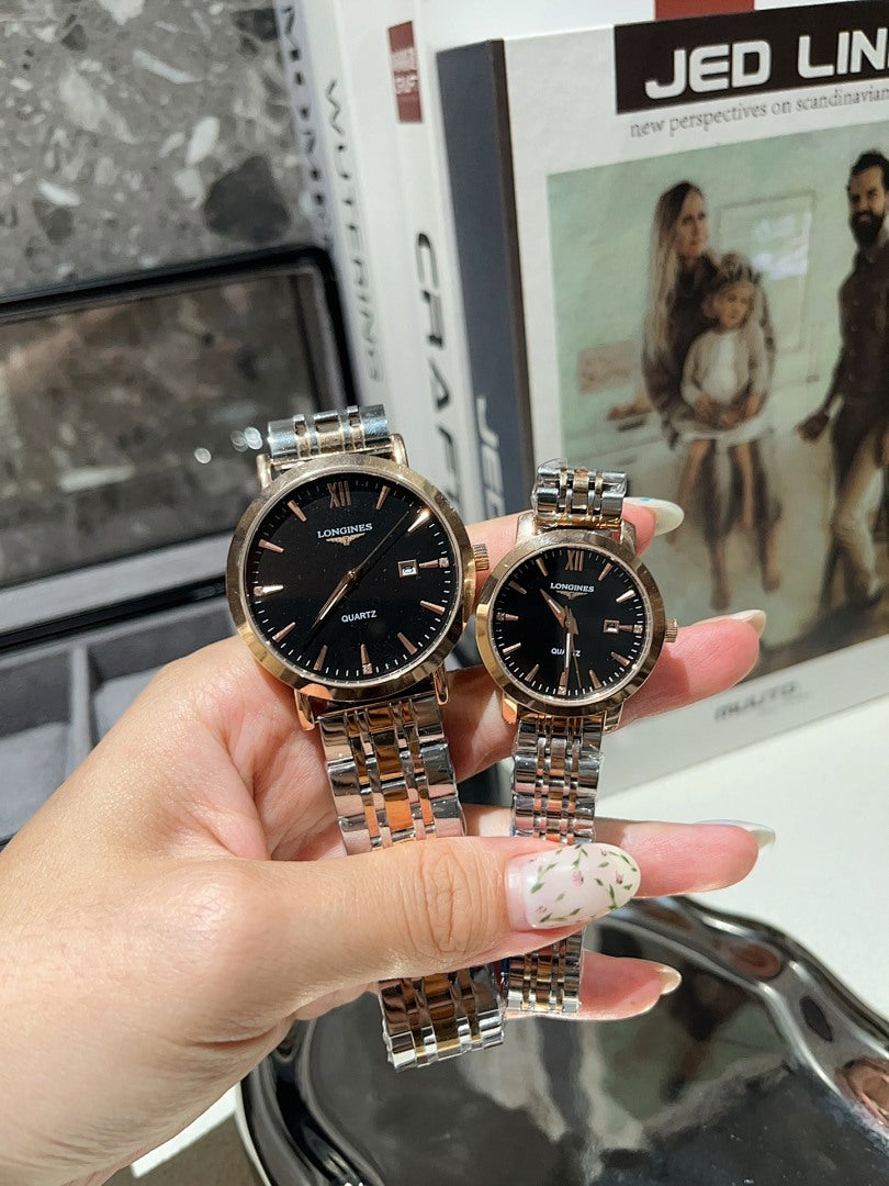 Longines watch with dark dial and silver metal bracelet, shown held in a hand