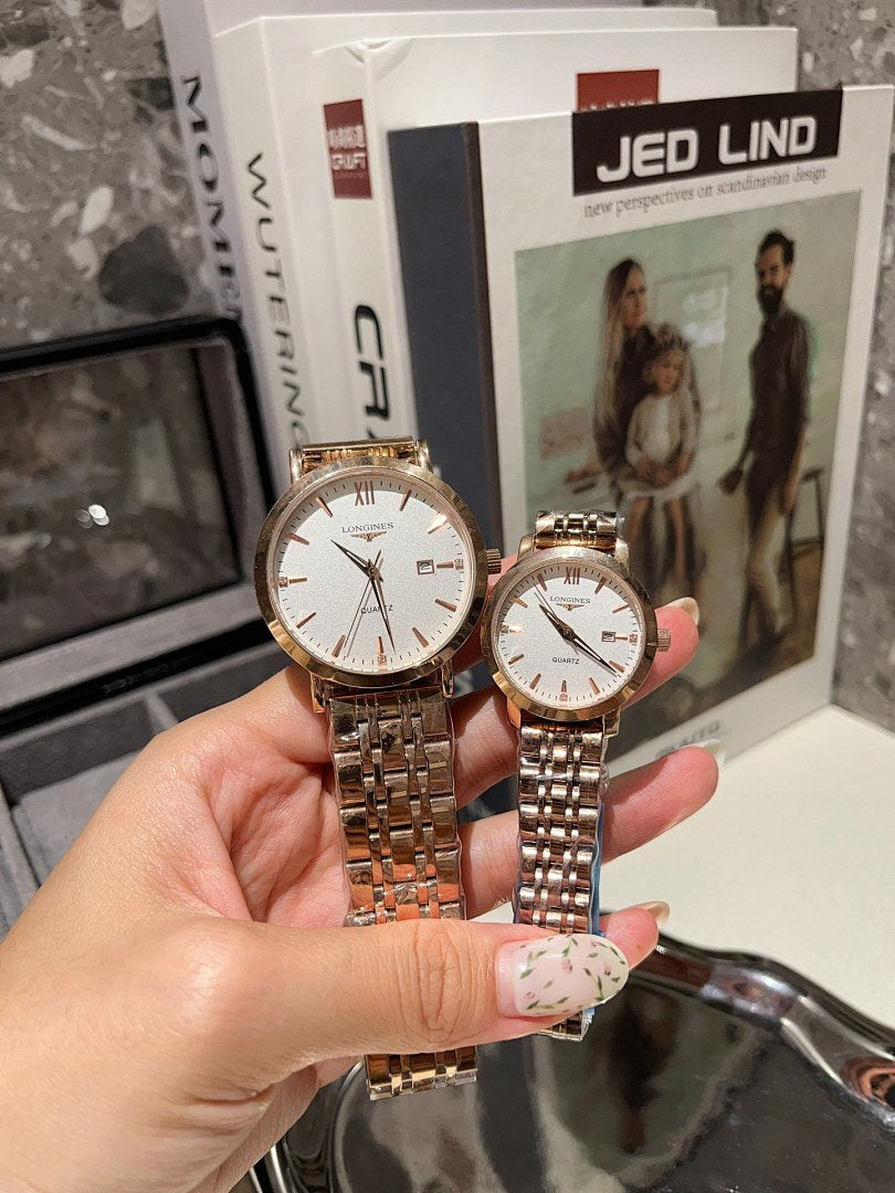 Longines watch with white dial and rose gold tone bracelet held in a hand