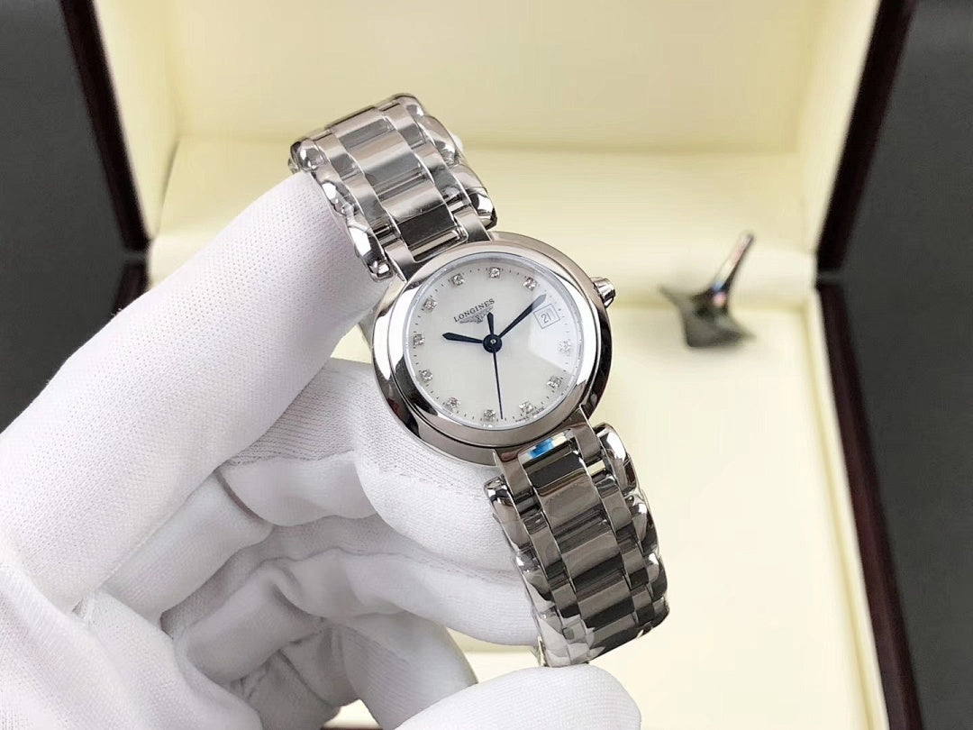 Longines watch on white display cushion with silver bracelet and white dial