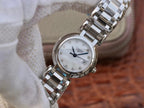Longines watch close-up with silver bracelet and white dial on brown surface