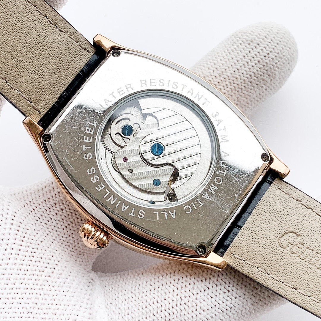 Longines case back with engraved pattern and blue accents, beige leather strap