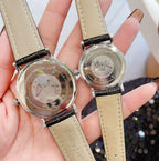 Longines wristwatch pair with engraved silver backs and beige leather straps, round cases