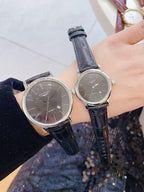 Longines wristwatch pair with dark dials and navy blue leather straps, round silver-tone cases