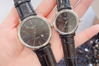 Longines wristwatch pair close-up with dark dials and black leather straps, round steel cases