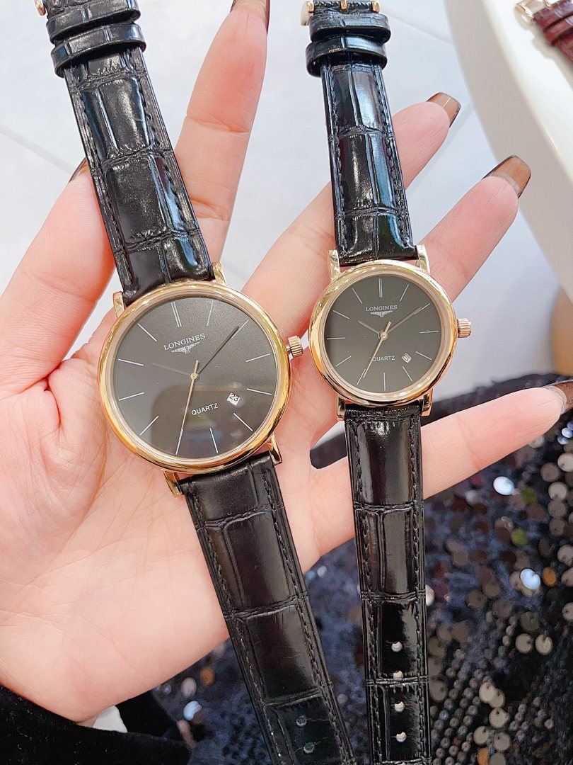 Longines wristwatch pair with dark dials and black leather straps, gold-tone round cases