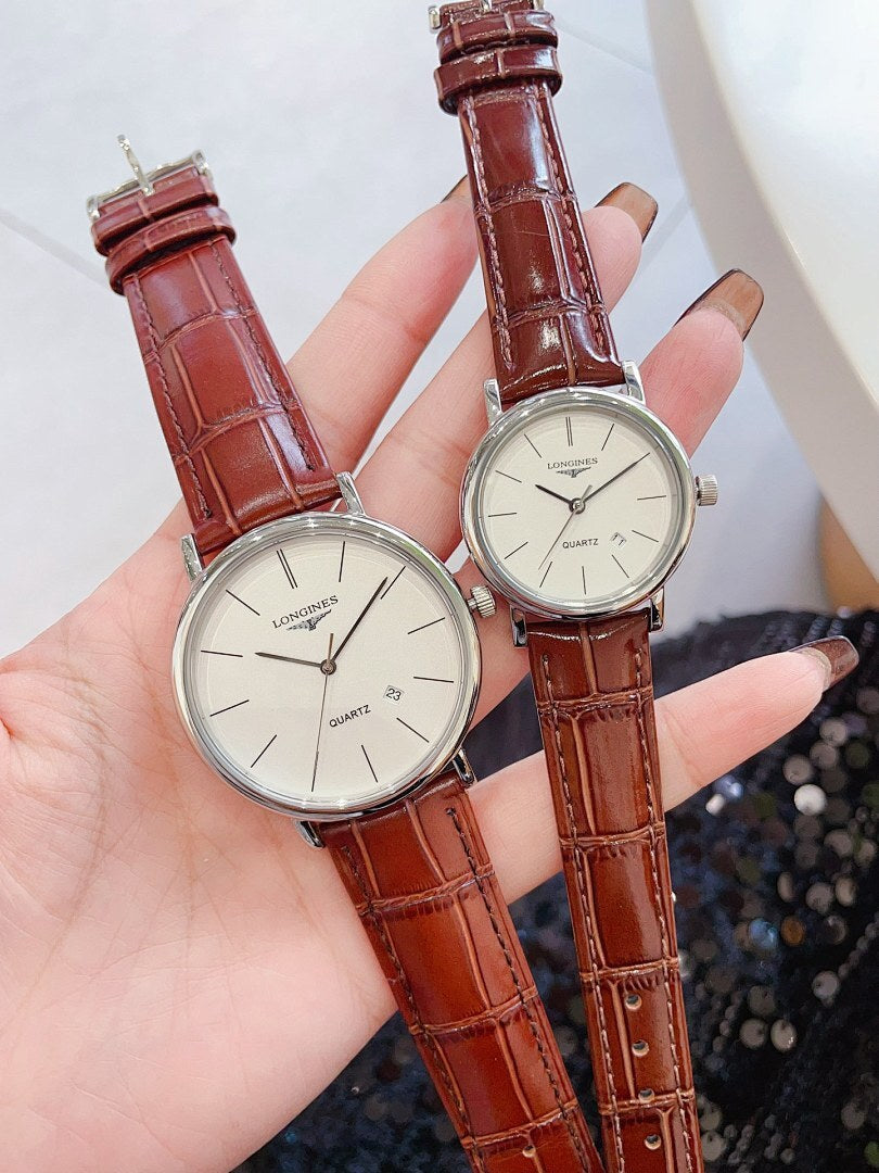 Longines wristwatch pair with dark dials, dark leather straps and gold-tone round cases