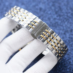 Two-tone watch bracelet segment in stainless steel with gold insets and clasp