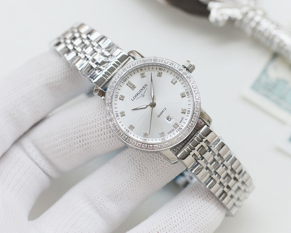 Wristwatch with silver metal bracelet, white dial and crystal-studded bezel
