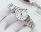 Wristwatch with silver metal bracelet, white dial and crystal-studded bezel