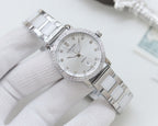 Wristwatch with silver case and link bracelet, white crystal-studded bezel dial
