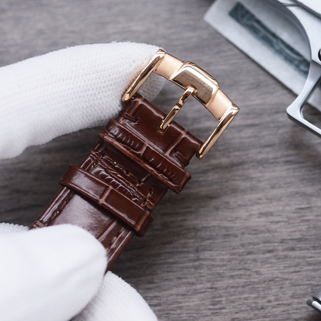 Longines leather watch strap with buckle, brown crocodile-style texture, gold-tone clasp.