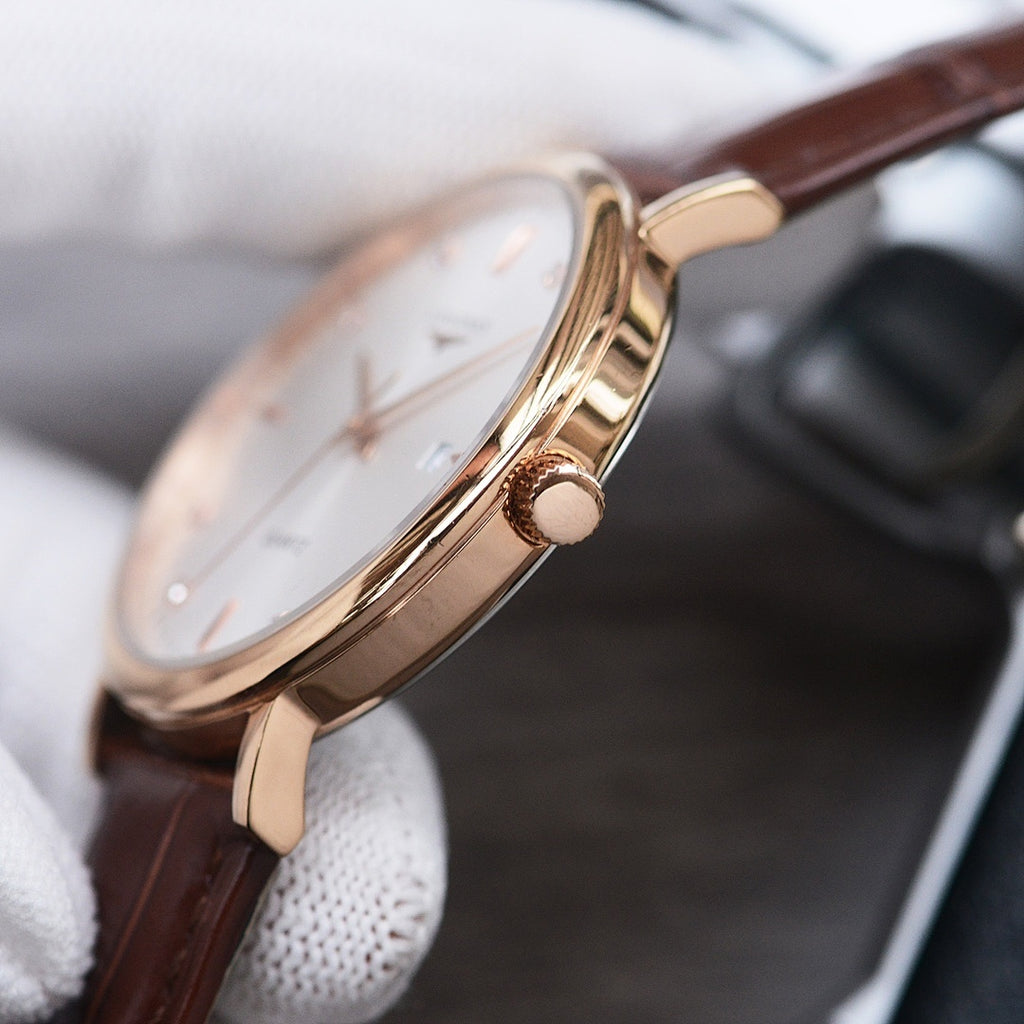 Longines watch case with crown and gold-tone finish, brown leather strap, round bezel.