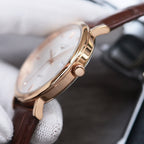 Longines watch case with crown and gold-tone finish, brown leather strap, round bezel.