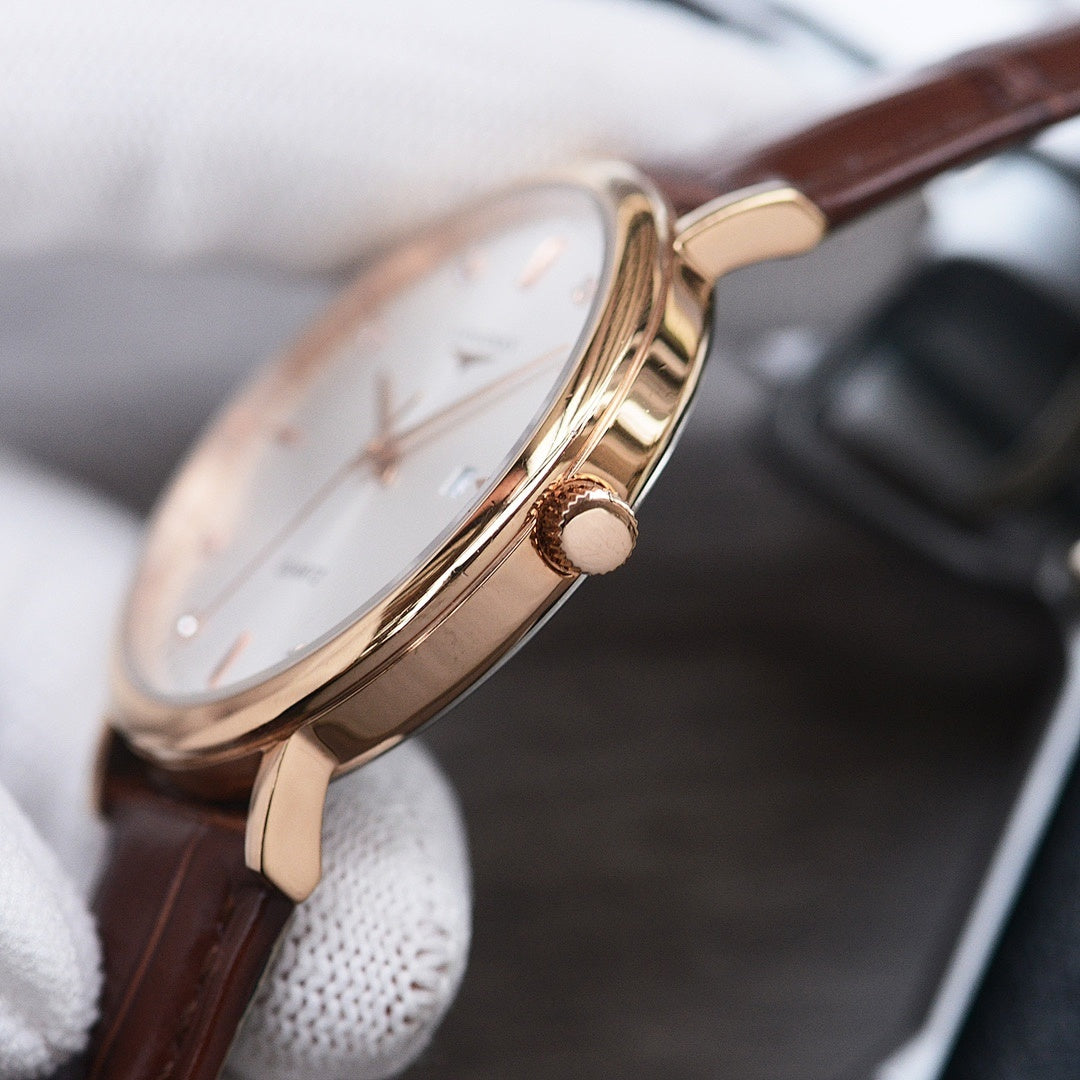 Longines watch case with crown and gold-tone finish, brown leather strap, round bezel.