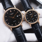 Longines watch pair with black dials, black leather straps, gold-tone cases, quartz text.