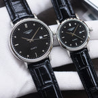 Longines watch pair with black dials, black leather straps, silver-tone cases, quartz branding.