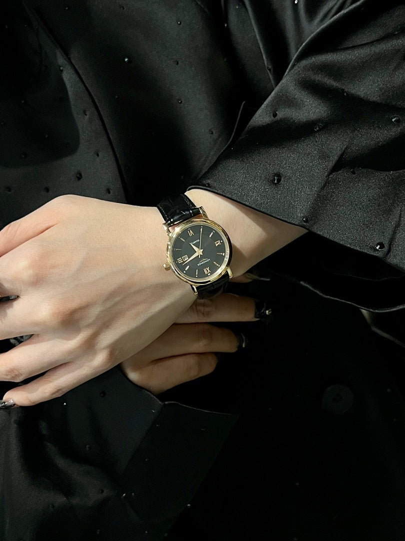 Luxury wrist watch with dark dial and black leather strap on a wrist