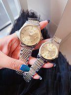 Longines wristwatch, champagne dial with gold hands, steel link bracelet.